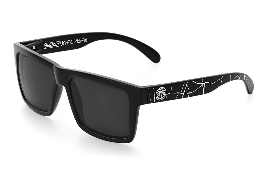 Heat Wave Visual Vise Sunglasses with black frame, shreddy crack print arms and black lenses.