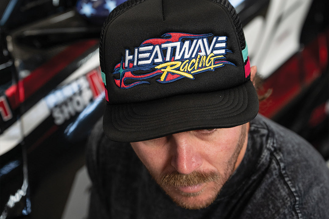 Man wearing the Black Heat Wave Y2K Racing Hat 