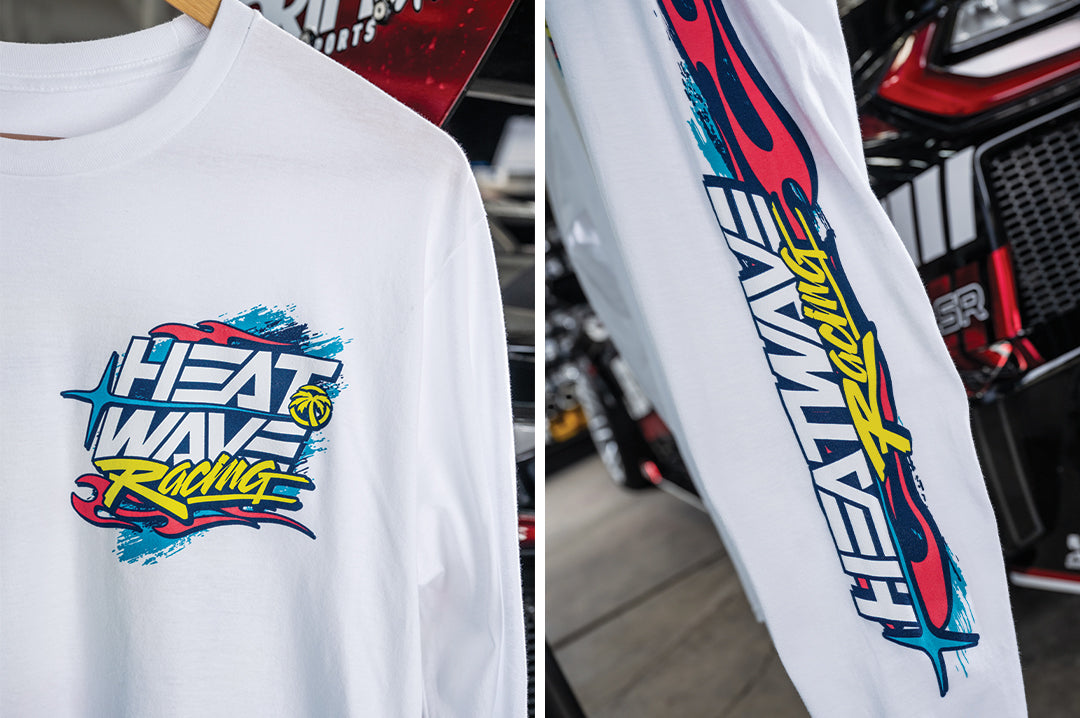 Close up shots of the Heat Wave Y2K Racing White Long Sleeve T-Shirt hanging in front of a car