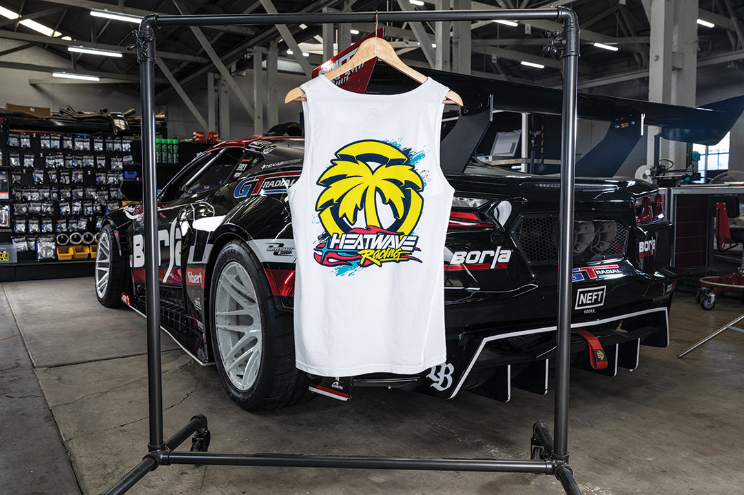 The Heat Wave Y2K White Tank Top hanging in front of a car