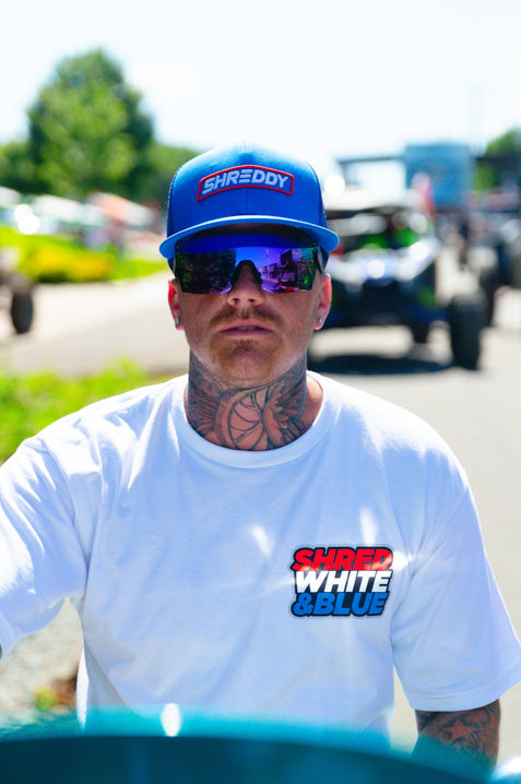 Motorcycle rider wearing the Heat Wave Visual Lazer Face Sunglasses with black frame, shreddy bug print arms and ultra violet lens.