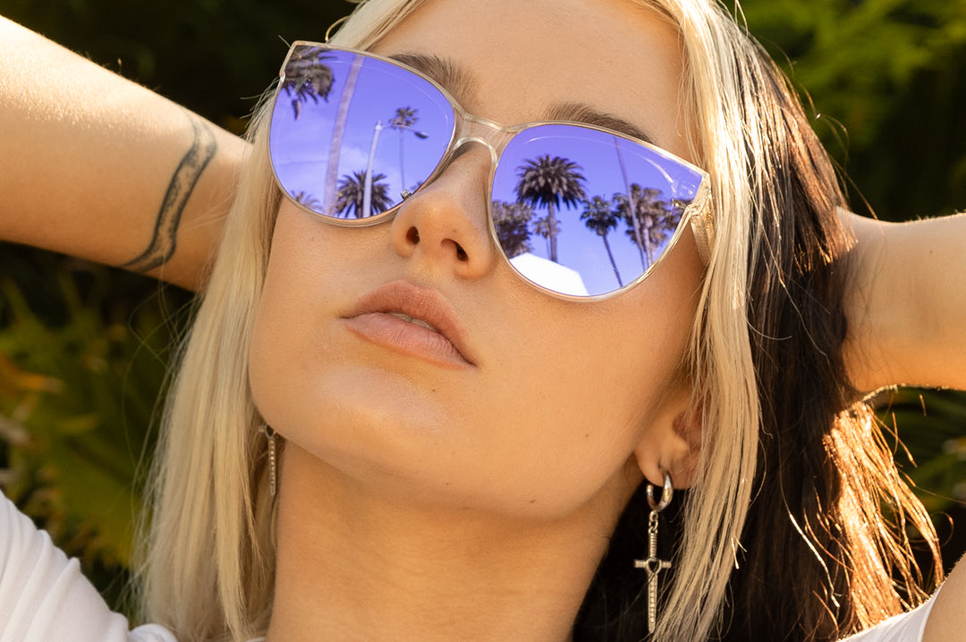 Young women in Beverly Hills wearing the Heat Wave Visual Carat Sunglasses with clear sparkle frame and ultra violet lenses.