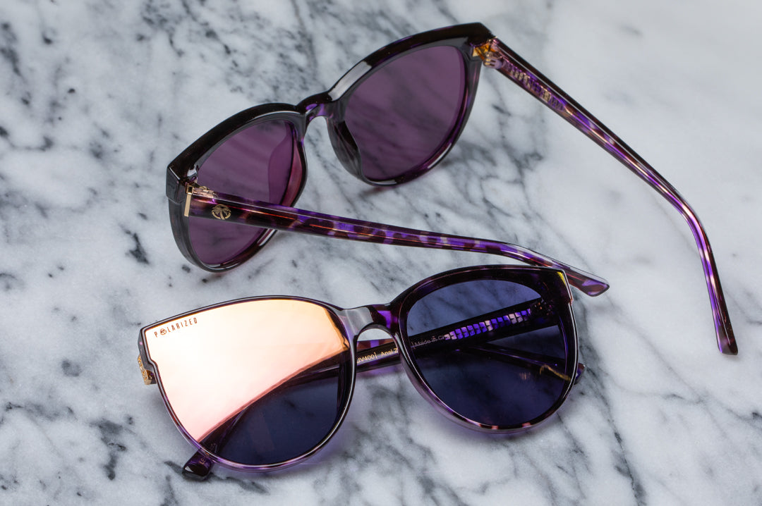 A pair of the Heat Wave Visual Women's Carat Sunglasses with velvet tortoise frame sitting on a marble counter.
