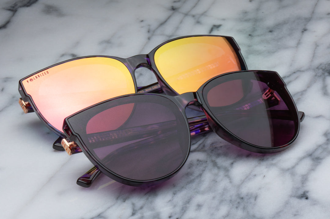 Sitting on a marble table is the Heat Wave Visual Women's Carat Sunglasses with velvet tortoise frame.