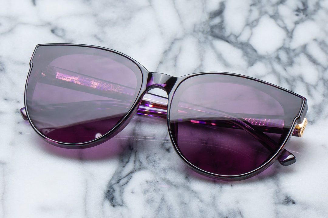 Front view of the Heat Wave Visual Women's Carat Sunglasses with velvet tortoise frame and purple lenses.