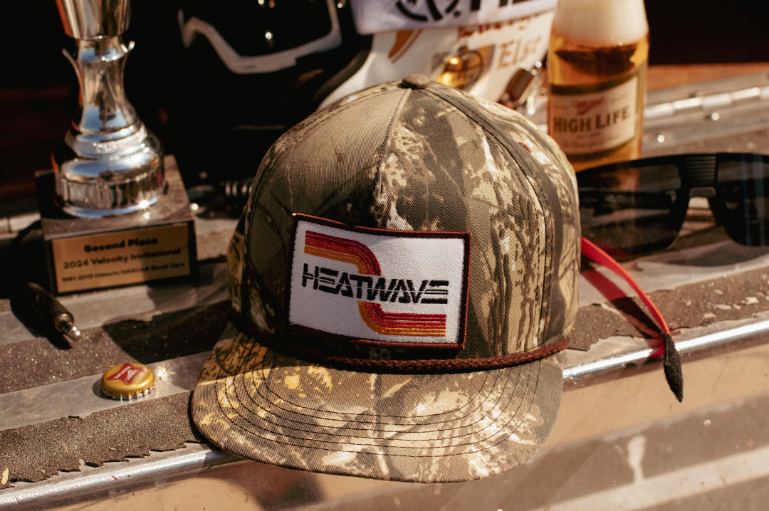 The Heat Wave Visual Chopper Hunter hat laying on the ground.