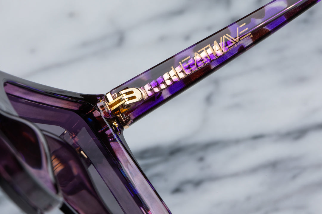 Inner arm detail of the Heat Wave Visual Women's Clarity Sunglasses with velvet tortoise frame and purple lens.
