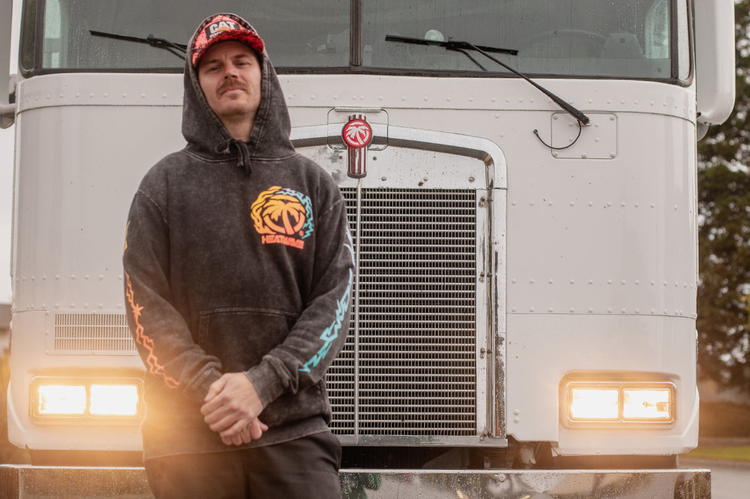 Justin wearing the Fire and Ice sweatshirt standing in front of the K100.