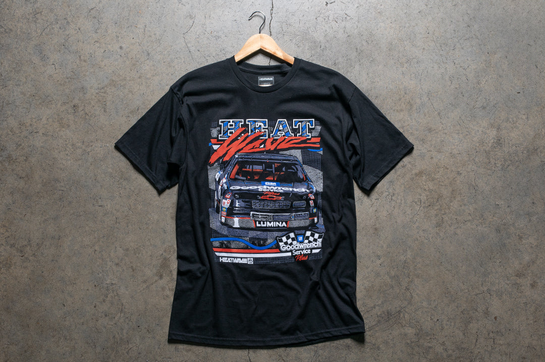 Laying on the ground is the Heat Wave Visual GM Goodwrench t-shirt in black. 