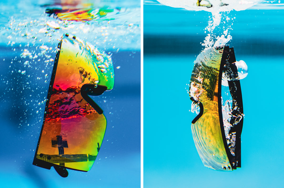 Submerged under water is the Heat Wave Visual H2O Lazer Face Sunglasses with black frame and atmosphere red blue lens.