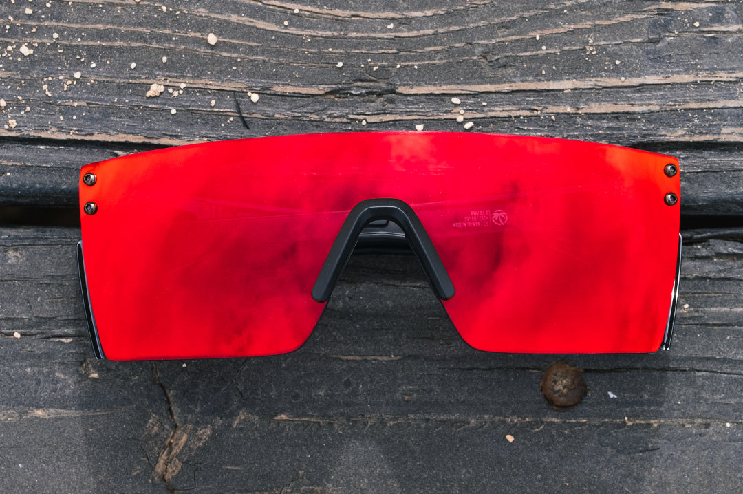 Front view of the Heat Wave Visual Performance Lazer SLIM Sunglasses with black frame, firestorm red lens and side shields.