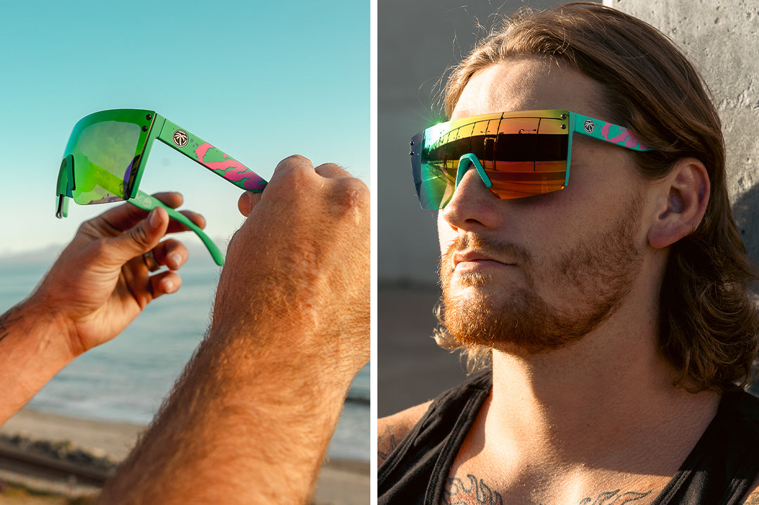 Long haired surfer wearing the Heat Wave Visual Lazer Face Sungalsses with teal frame, hypersplash arms and spectrum pink yellow lens. 