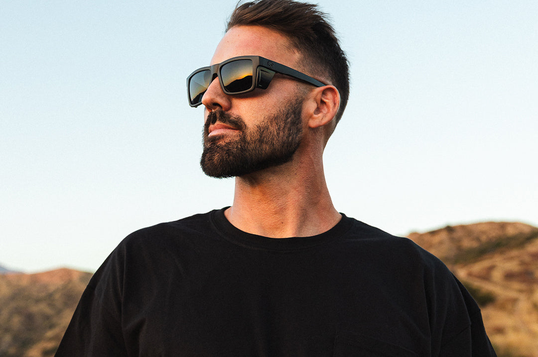 Young dude wearing the Heat Wave Visual Performance Vise Sunglasses with black frame and ultra black lenses.