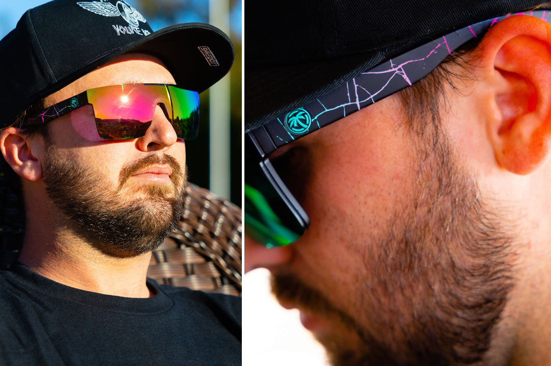 Bearded young man wearing Heat Wave Visual Quatro Sunglasses with black frame, Shreddy crack print arms and spectrum pink yellow lens.