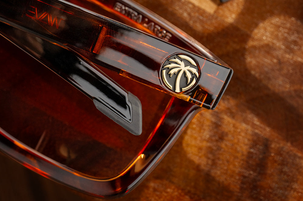 Close-up of the gold emblem on the Heat Wave Visual Performance XL Vise Tortoise Sunglasses.