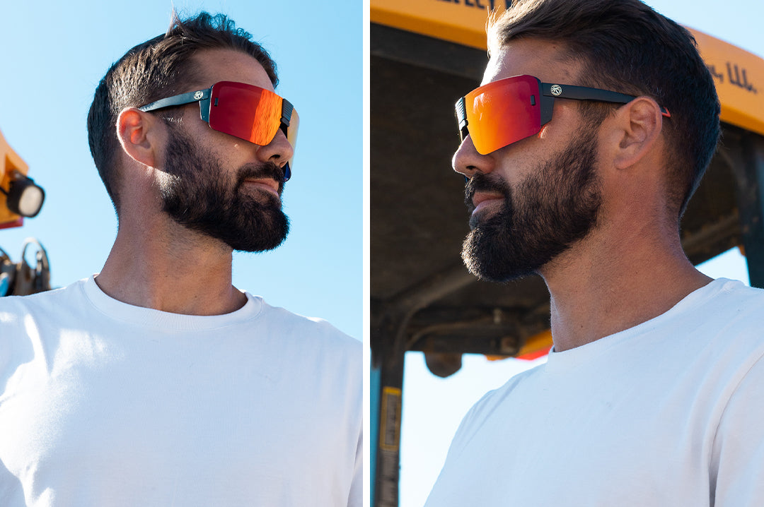 Worker wearing the Heat Wave Visual Vector Sunglasses with black frame and sunblast orange yellow lens. 