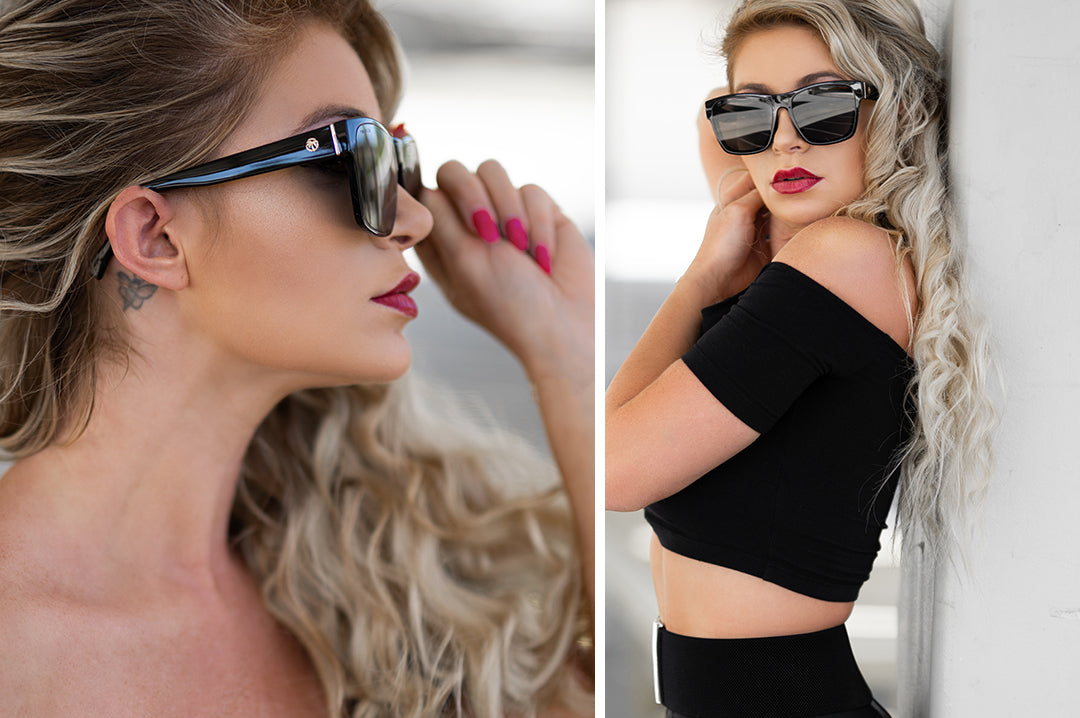Woman on vacation wearing Heat Wave Visual Womens Marylin Sunglasses with black frame and black lenses.