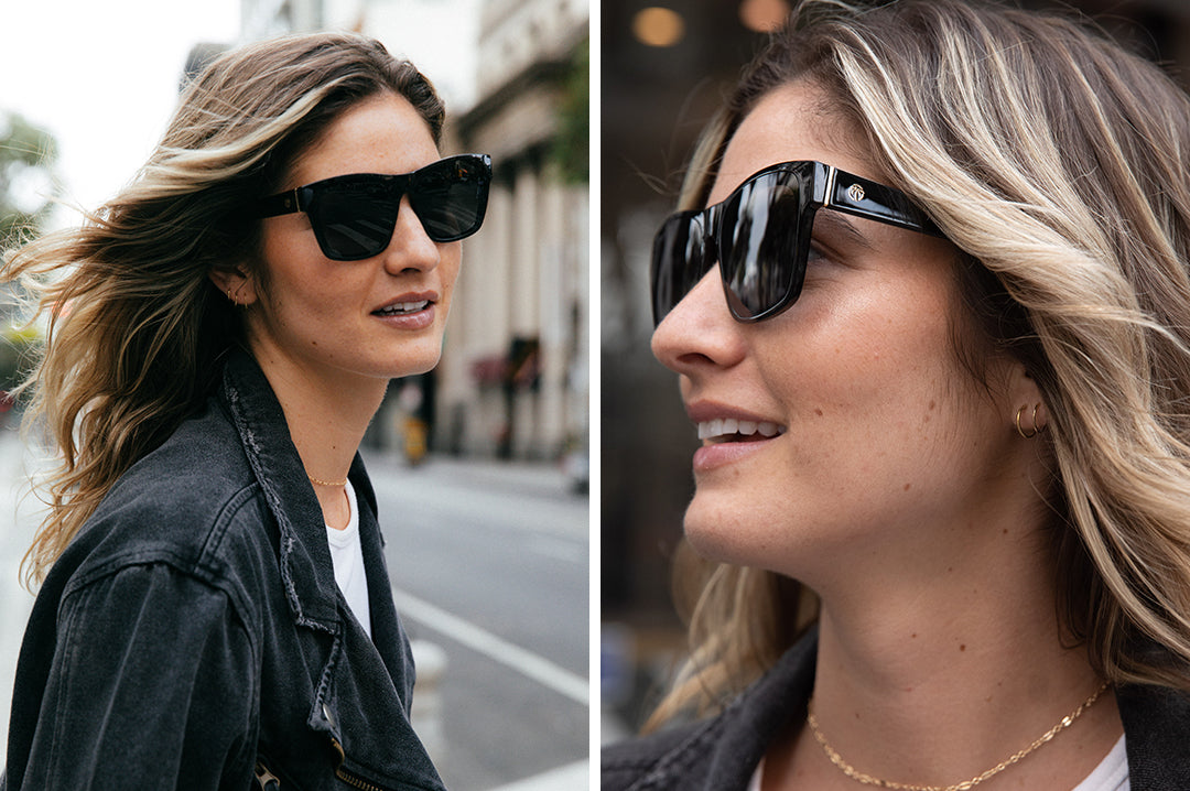 Woman in the city wearing Heat Wave Visual Womens Marylin Sunglasses with black frame and black lenses.