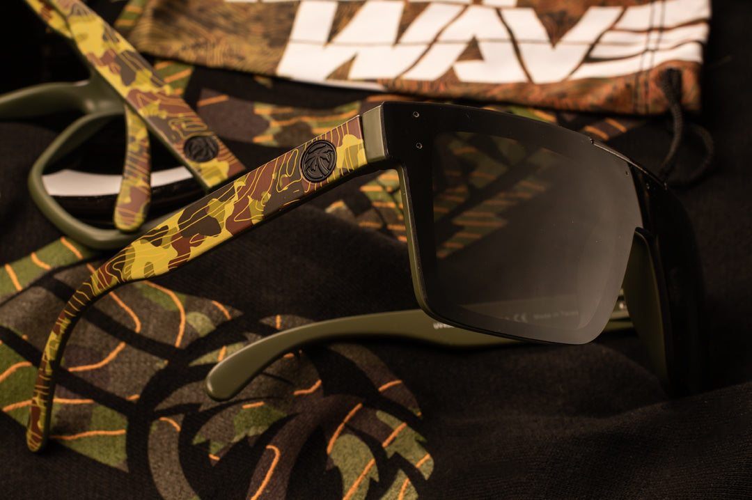 Side view of Heat Wave Visual Quatro Sunglasses with olive green frame, topo camo print arms and black ens.