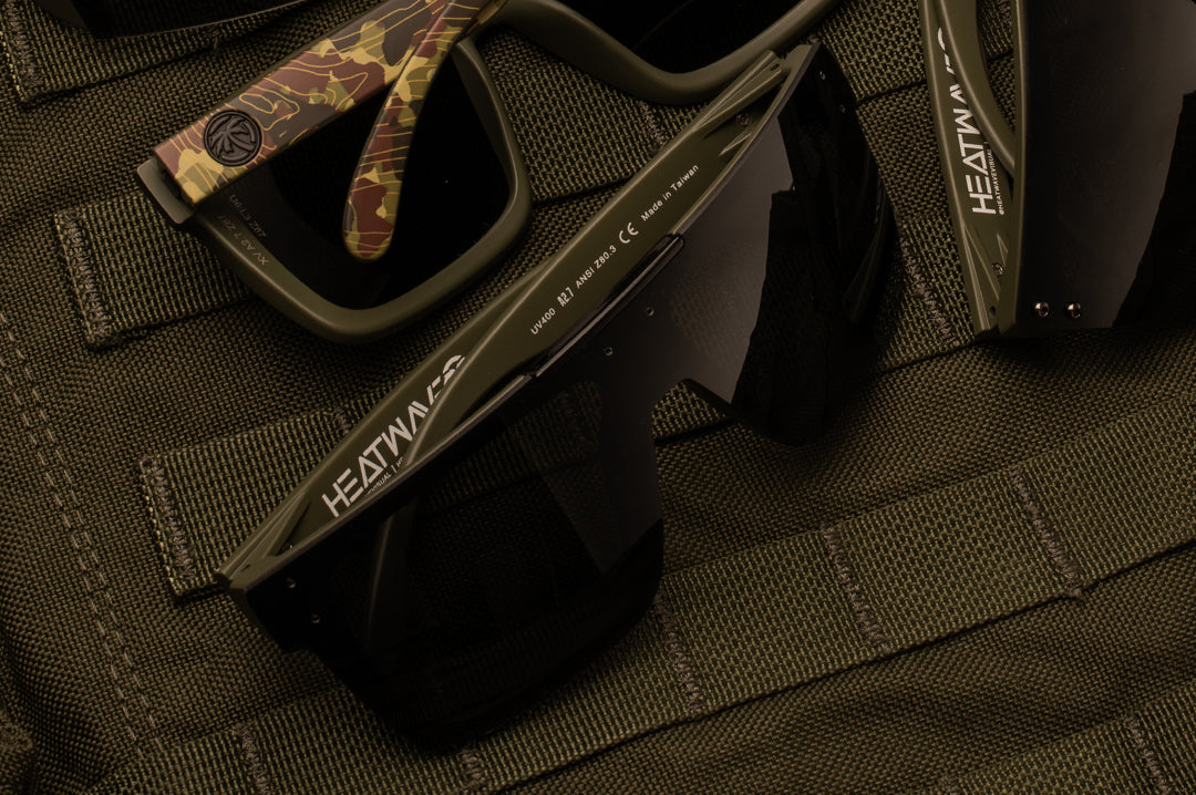 Clost up of Heat Wave Visual Quatro Sunglasses with olive green frame, topo camo print arms and black lens.