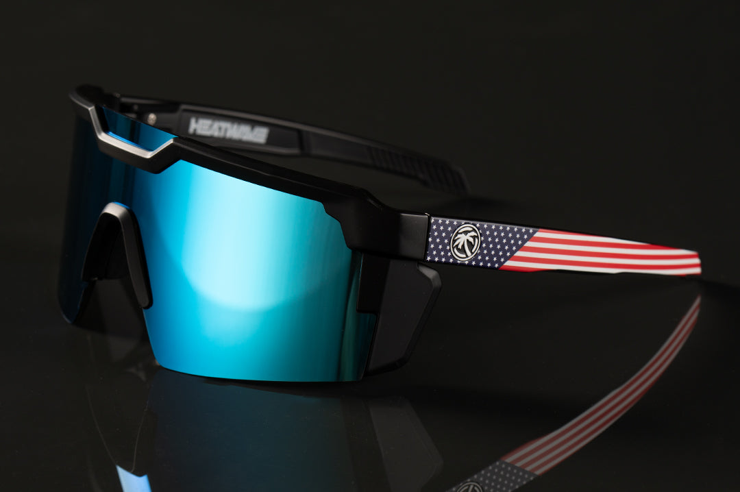 Heat Wave Visual Future Tech Sunglasses with black frame with USA print arms and galaxy blue lens.