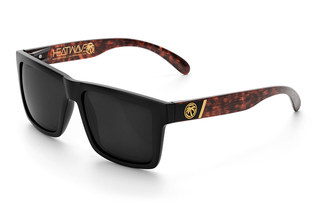 Heat Wave Visual Vise Sunglasses with black frame, woodgrain print arms and black lenses.
