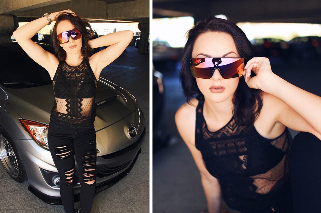 Car Girl wearing Heat Wave Visual Lazer Face Z87 Sunglasses with black frame and atmosphere red blue lens.