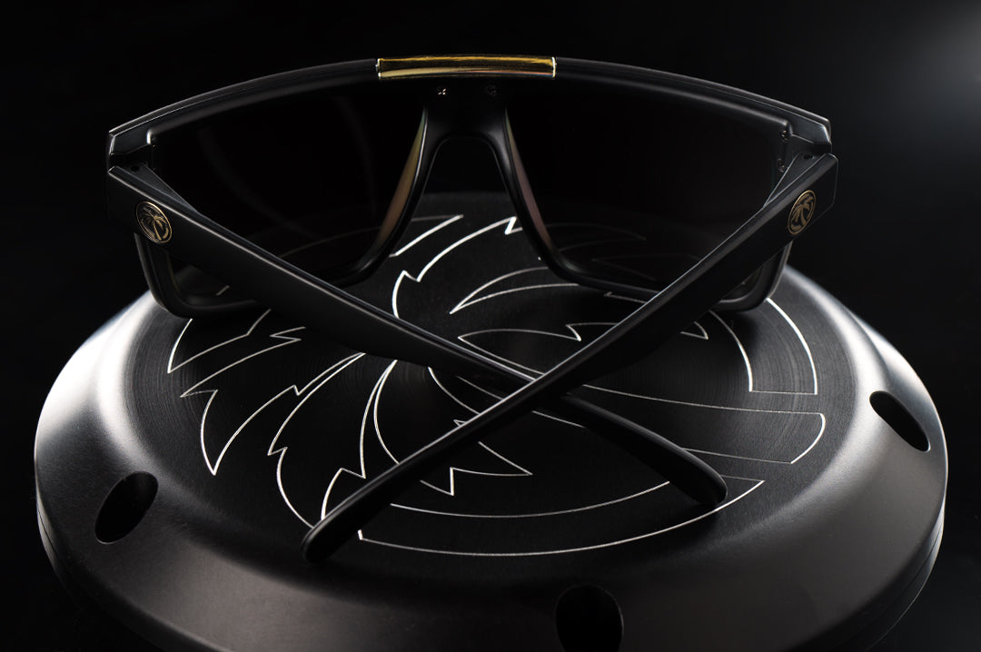 Heat Wave Visual Quatro black frame and gold lens on a Harley engine cover.