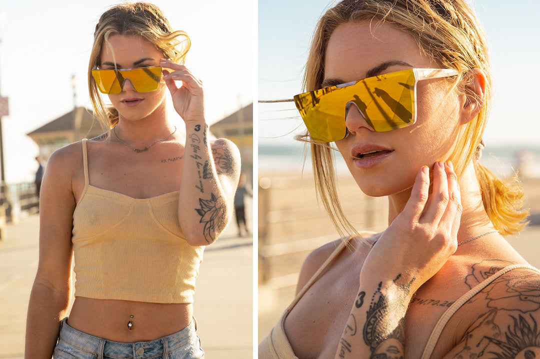 Young woman wearing Heat Wave Visual Womens Clarity Sunglasses with marble frame and gold lens.
