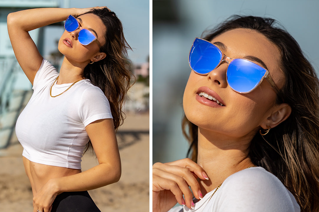 Women at the beach wearing the Heat Wave Visual Carat Sunglasses with clear sparkle frames and ultra violet lenses.