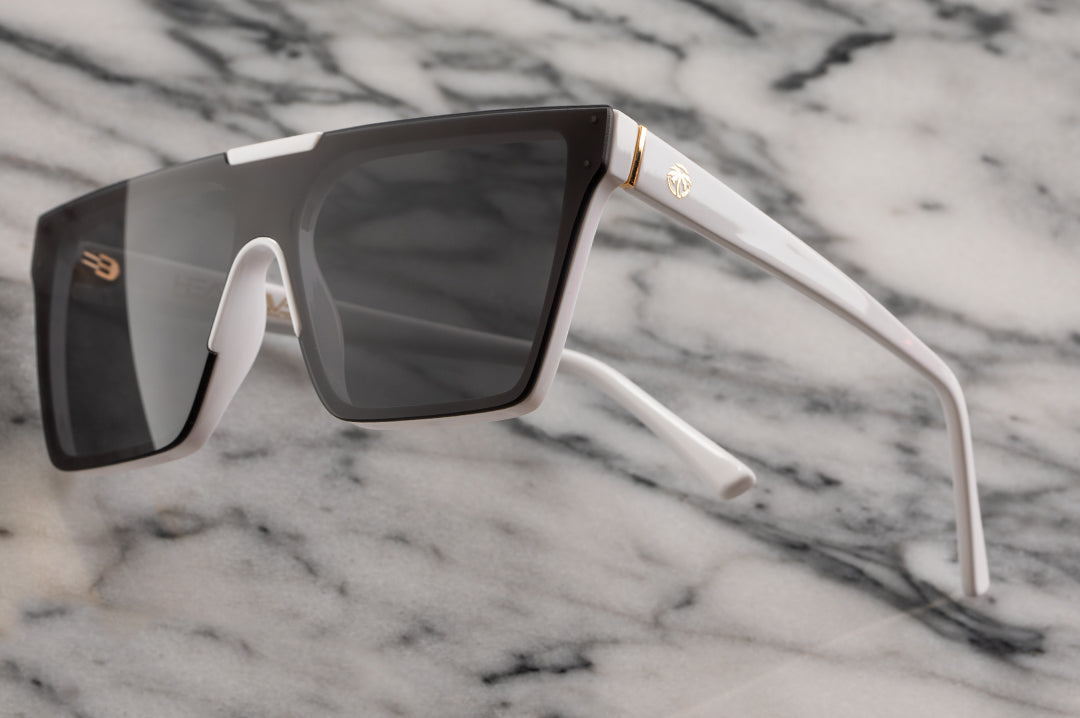 Side view of Heat Wave Visual Womens Clarity Sunglasses with white frame and black lens.