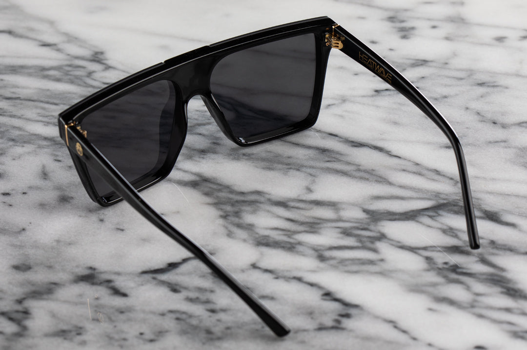 Back of Heat Wave Visual Clarity Sunglasses with black frame and rose gold lens.