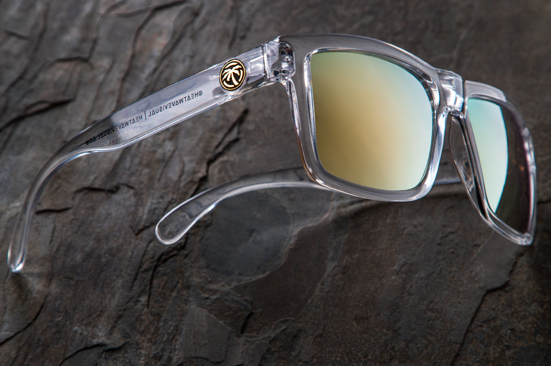 Side view of Heat Wave Visual Clear Vise Sunglasses on a rock.