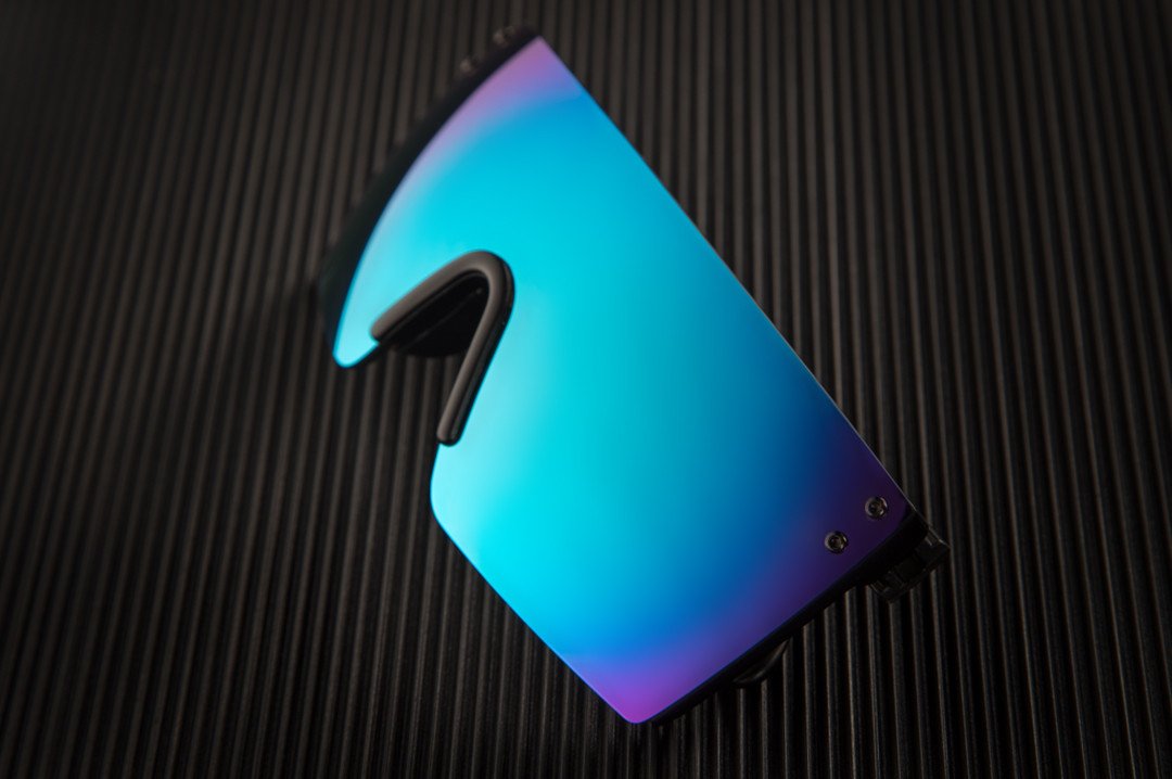 Heat Wave Visual Lazer Face Z87 Sunglasses with black frame and galaxy blue lens on a black table.