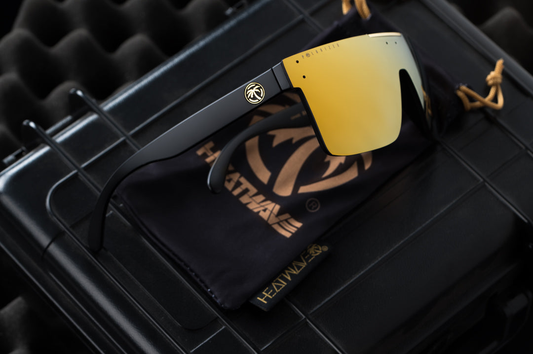 Side view of Heat Wave Visual Quatro black frame and gold lens.
