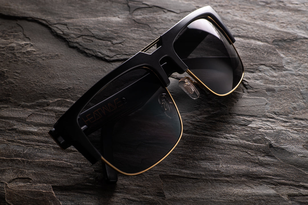 Front of Heat Wave Visual Interceptor Sunglasses with black gold frame and black lenses.