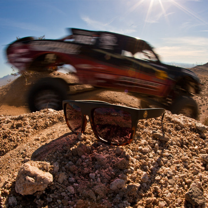 Truck racing behind the Front Heat Wave Visual Regulator Sunglasses with black and tortoise brown frame and brown gradient lenses.