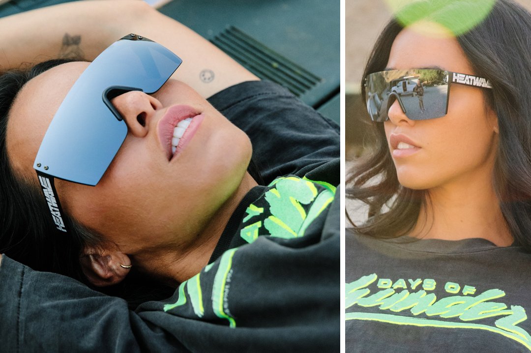 Women lying down wearing Heat Wave Visual Lazer Face Sunglasses with black frame, billboard print arms and silver lens.