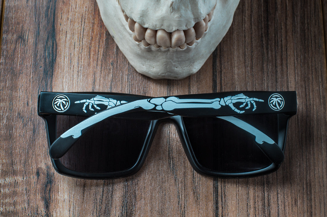 Back view of Heat Wave Visual Vise Sunglasses with black frame, bones print arms and black lenses. 