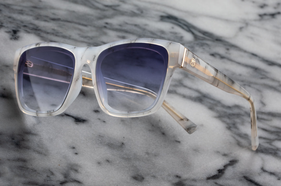 Side view of Heat Wave Visual Womens Marylin Sunglasses with marble frame and purple gradient lenses.