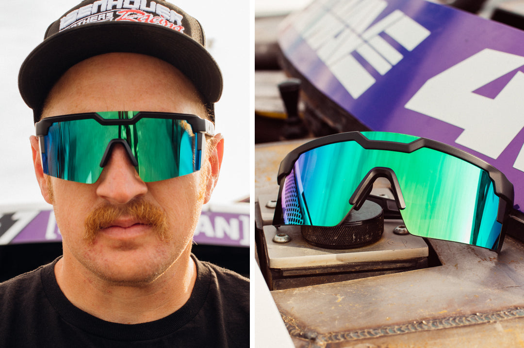 Mustached man wearing Heat Wave Visual Future Tech Sunglasses with black frame and piff green lens.