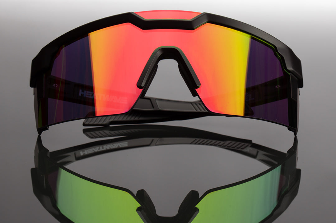 Front of Heat Wave Visual Future Tech Sunglasses with black frame and spectrum pink lens.