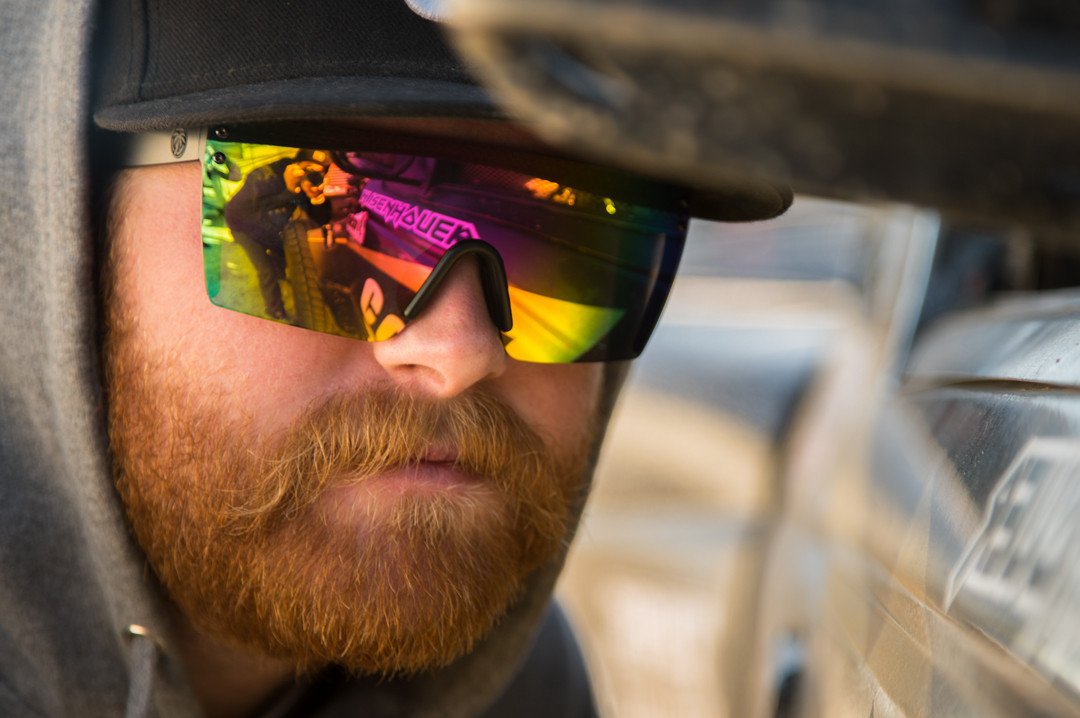 Nick Isenhouer wearing Heat Wave Visual Lazer Face Z87 Sunglasses with black frame and spectrum pink yellow lens.