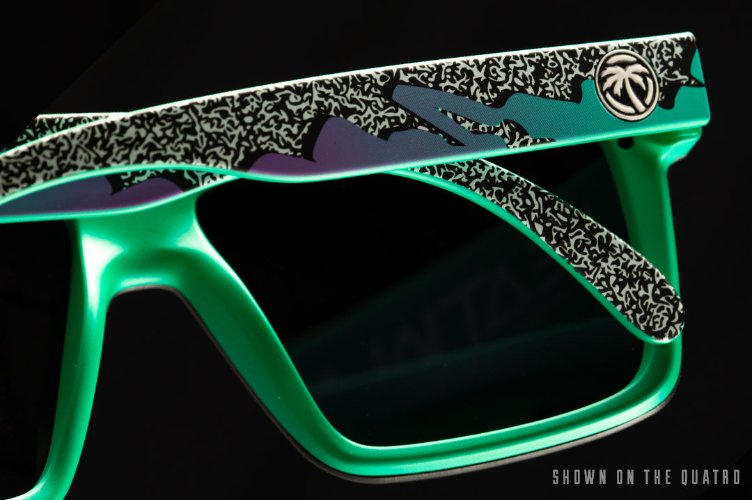 Back of Heat Wave Visual Quatro Sunglasses with green frame, eighties themed print arms and ultra violet lens.