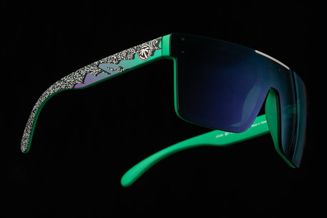 Side view of Heat Wave Visual Quatro Sunglasses with green frame, eighties themed print arms and ultra violet lens.