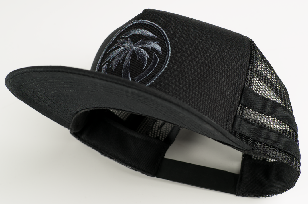 Bottom of Heat Wave Visual black trucker hat with socom patch.