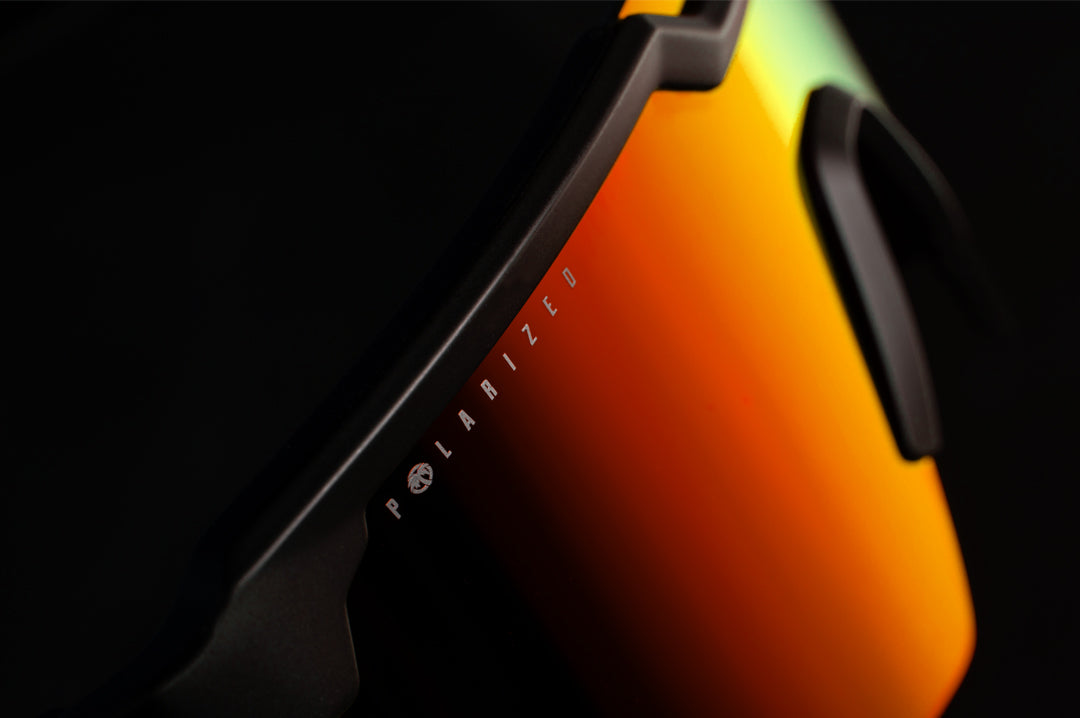 Heat Wave Visual Future Tech Sunglasses with black frame and polarized sunblast orange yellow lens.