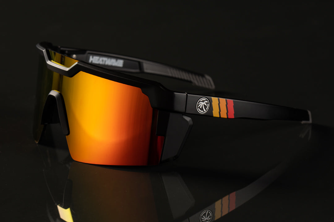 Side of Heat Wave Visual Future Tech Sunglasses with black frame with turbo print arms and orange yellow lens.