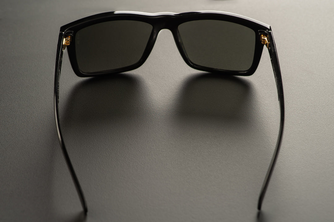 Back view of Heat Wave Visual USA made Vise Sunglasses with gloss black frame and black lenses.
